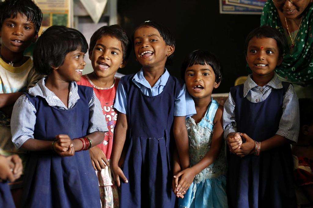 Students actively engaged in a course with digital devices in a bright classroom setting
